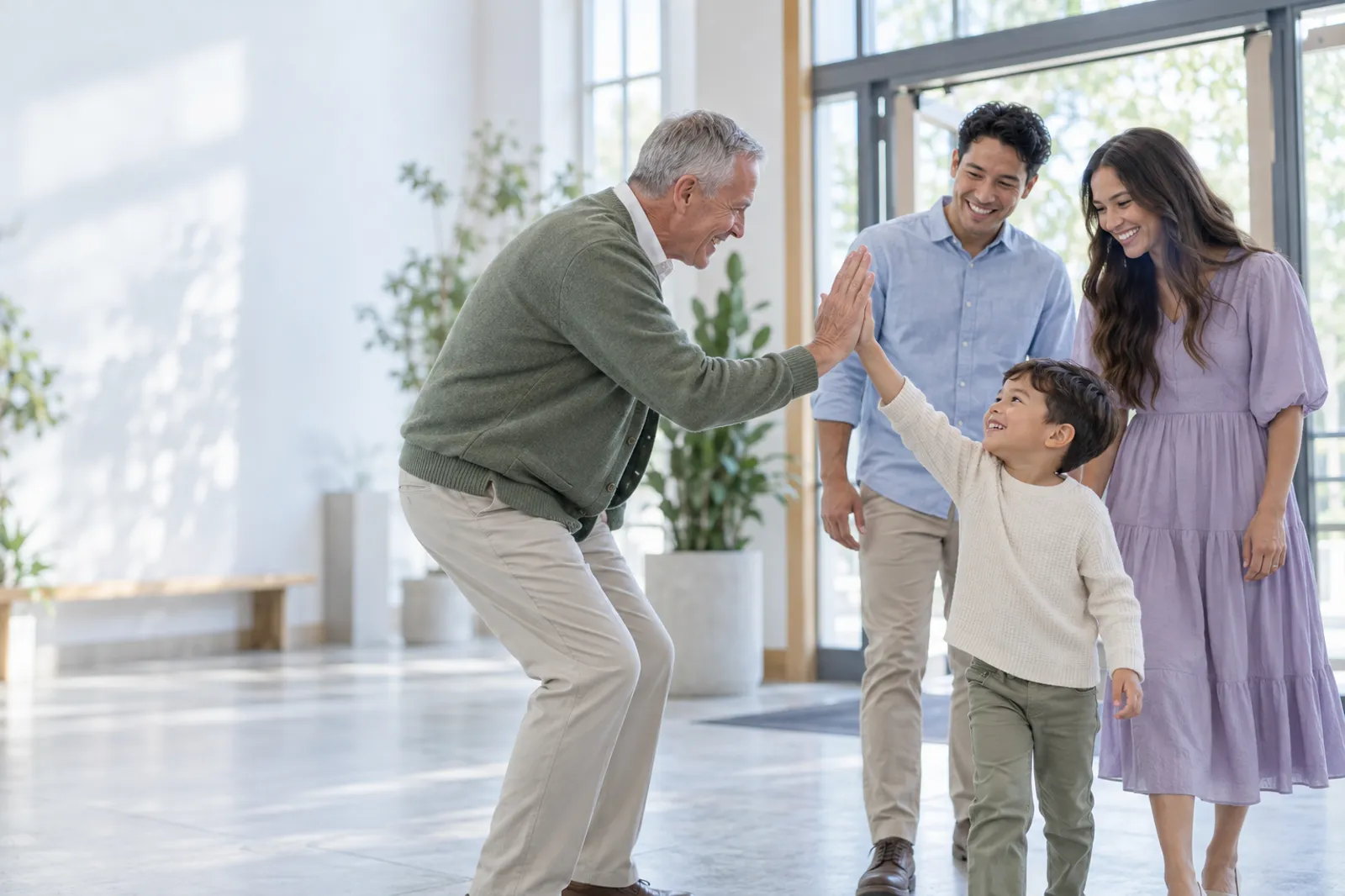 A greeter high-fives a child as a family returns to church the next Sunday